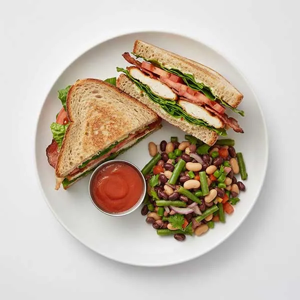 Smoky Chicken blt sandwich with cocktail sauce and house bean salad